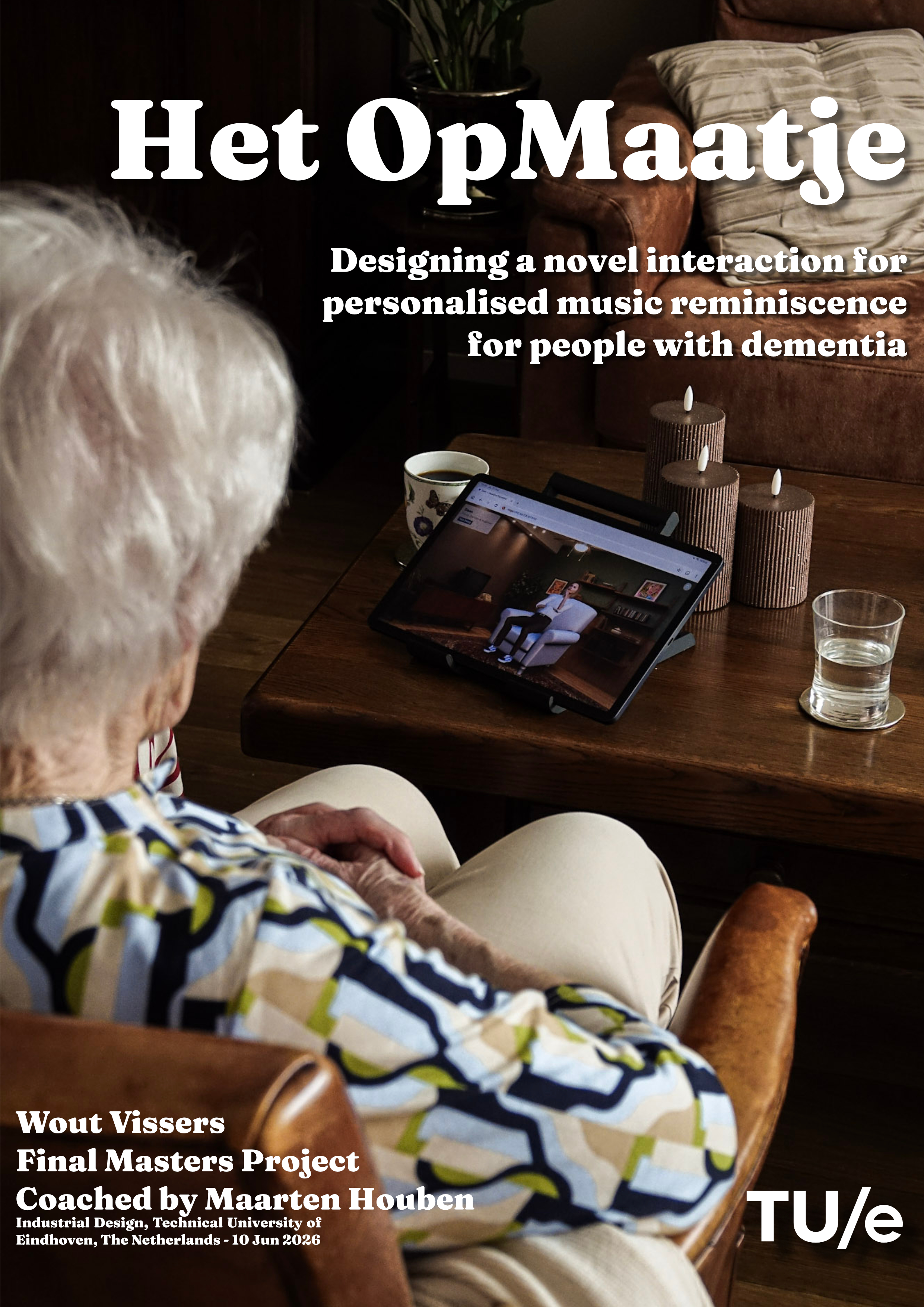 An older woman using OpMaatje on a tablet, sitting in her armchair with coffee and candles on the table